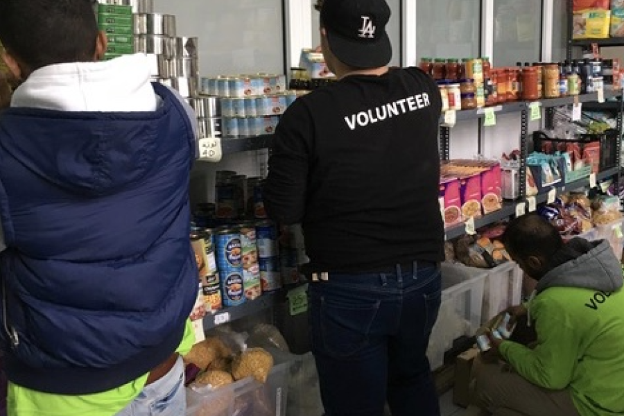 Volunteers arranging non perishable food.